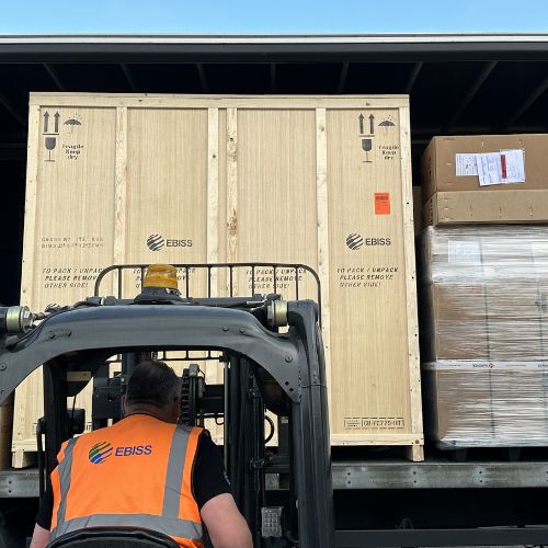 EBISS art crate being loaded onto a large truck by forklift